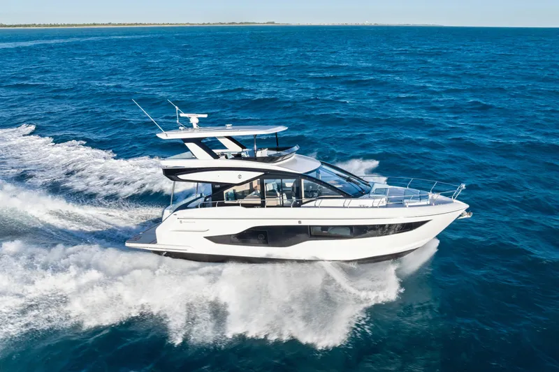 Slide: The Image of 2026 Cruisers 50 Fly yacht cruising on open blue sea. - 11