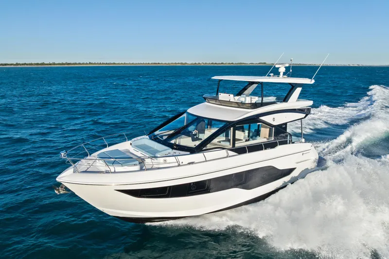 Slide: The Image of 2026 Cruisers 50 Fly yacht cruising on open blue waters. - 2