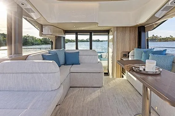 Slide: The Image of Luxurious interior of 2026 Cruisers 50 Fly yacht with modern seating and scenic water view. - 27