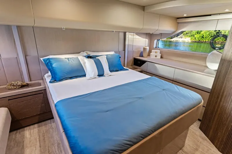 Slide: The Image of Luxurious bedroom interior of 2026 Cruisers 50 Fly yacht with elegant decor and scenic window view. - 30