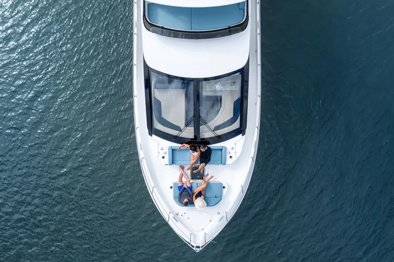 Slide: The Image of Aerial view of 2026 Cruisers 50 Fly yacht with people relaxing on deck. - 38