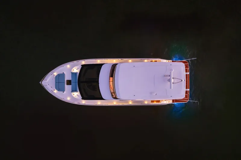 Slide: The Image of Aerial view of 2026 Cruisers 50 Fly yacht illuminated at night. - 46