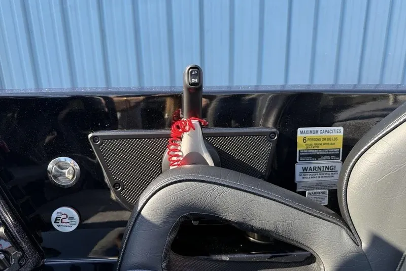 Slide: The Image of Control panel of 2026 Phoenix 920 Elite X boat with capacity warnings and throttle lever. - 11