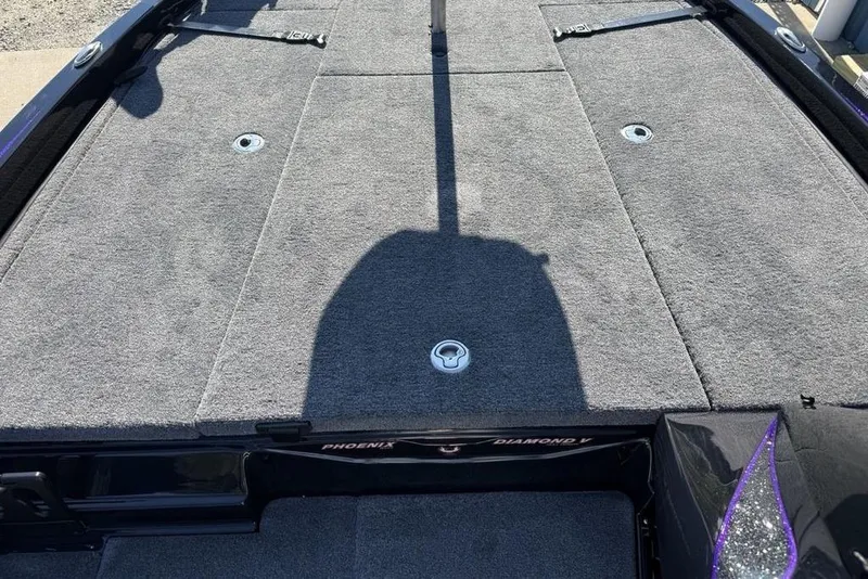 Slide: The Image of 2026 Phoenix 920 Elite X boat deck with gray carpet and storage compartments. - 12