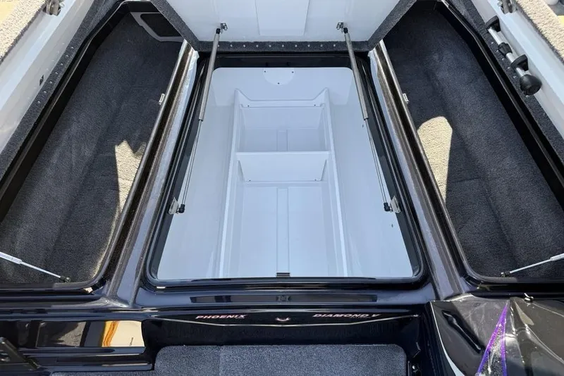 Slide: The Image of Open storage compartment in 2026 Phoenix 920 Elite X boat, featuring spacious interior design. - 15