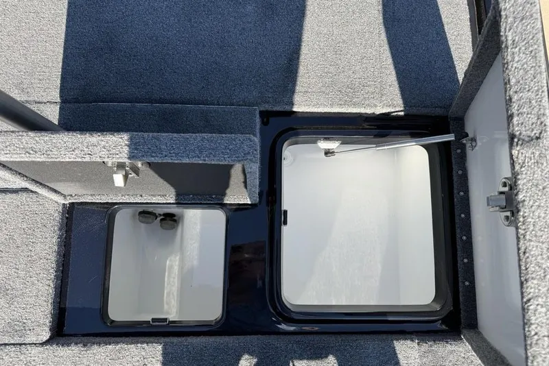 Slide: The Image of Open storage compartments in a 2026 Phoenix 920 Elite X boat interior. - 17
