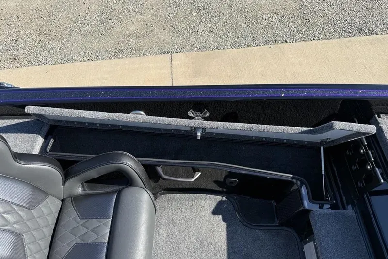 Slide: The Image of Interior of 2026 Phoenix 920 Elite X boat with open storage compartment. - 20