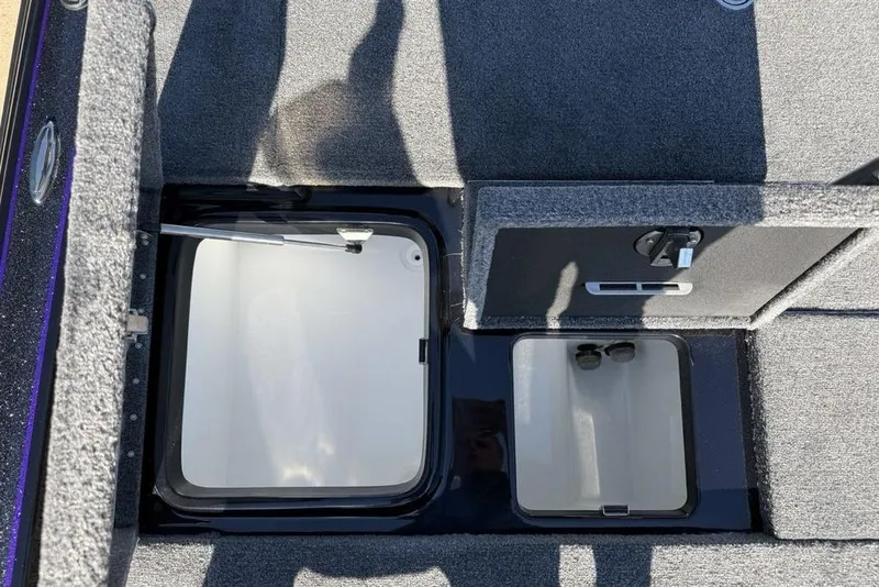 Slide: The Image of Interior storage compartments of 2026 Phoenix 920 Elite X boat, featuring carpeted surfaces. - 22