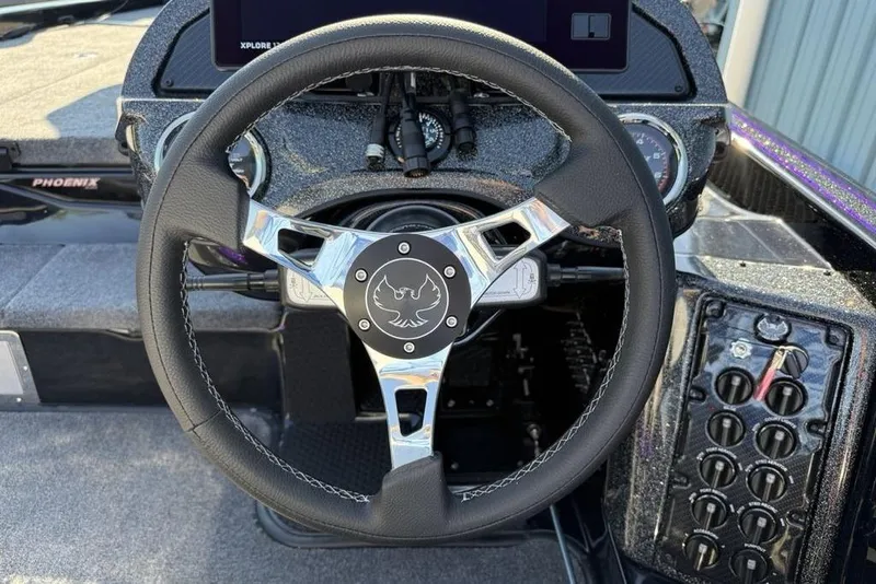 Slide: The Image of Steering wheel of 2026 Phoenix 920 Elite X boat with control panel. - 5