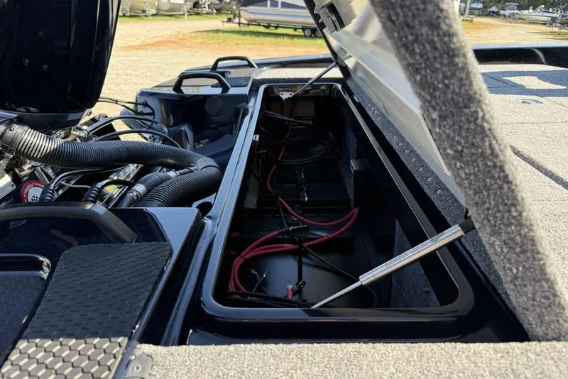 Slide: The Image of Open storage compartment of 2026 Phoenix 920 Elite X boat, showing engine and wiring. - 6