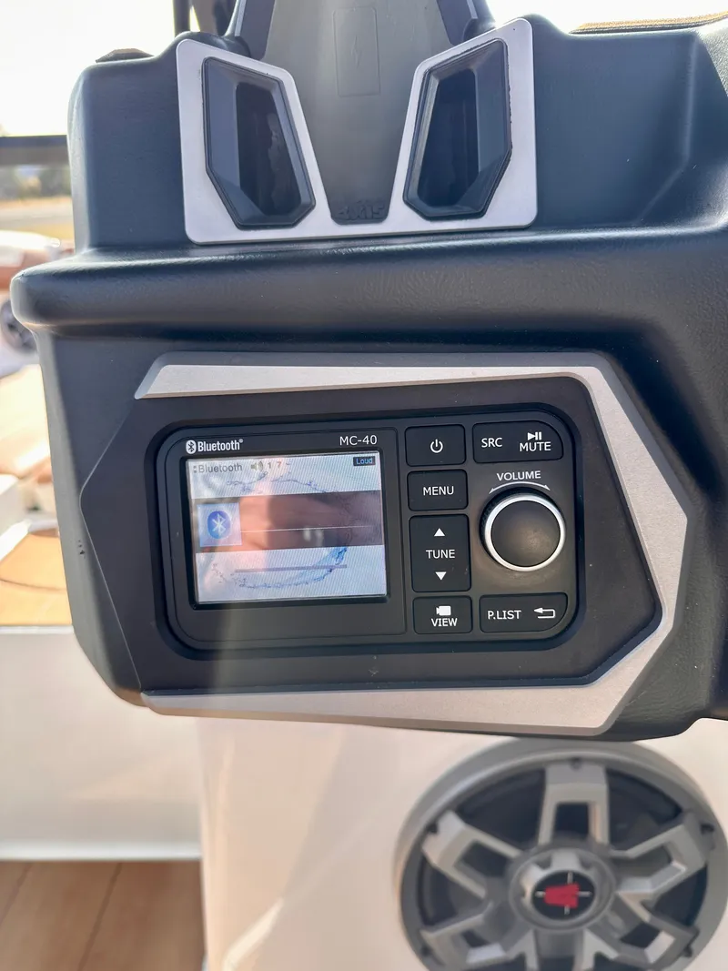 Slide: The Image of 2023 Axis A24 boat control panel with Bluetooth display and speaker. - 18