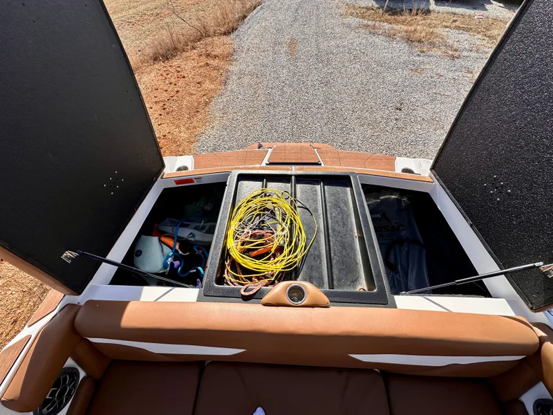 Slide: The Image of 2023 Axis Wake Research A24 boat with open storage and cables. - 19