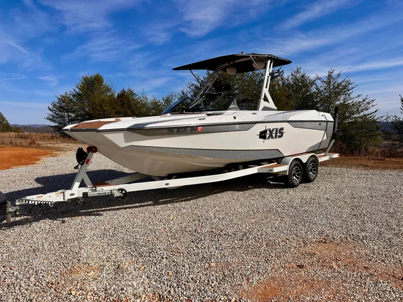 Slide: The Image of 2023 Axis Wake Research A24 boat on trailer, parked outdoors. - 3