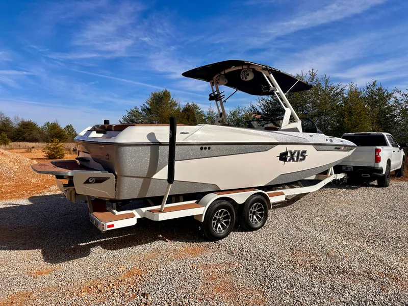 Slide: The Image of 2023 Axis Wake Research A24 boat on trailer outdoors. - 4