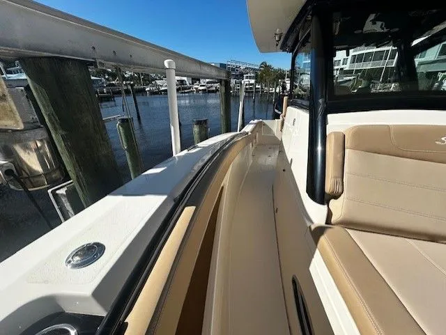 Slide: The Image of 2022 Scout 305 LXF boat docked at marina. - 11