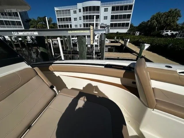 Slide: The Image of Scout 305 LXF 2022 boat at dock with seating area. - 17