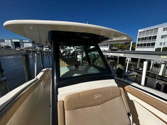 Slide: The Image of Scout 305 LXF 2022 boat docked under sunny skies. - 18
