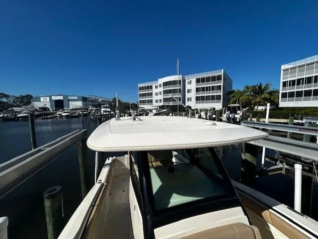 Slide: The Image of Scout 305 LXF 2022 boat docked in marina under sunny skies. - 19