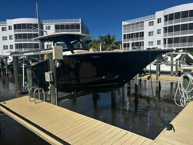 Slide: The Image of Scout 305 LXF 2022 on a dock in front of modern buildings. - 2