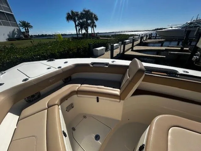 Slide: The Image of Scout 305 LXF 2022 boat with luxurious seating area at dock. - 23