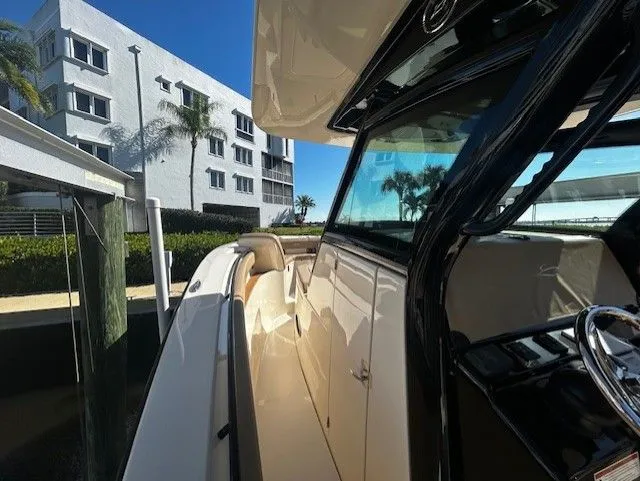 Slide: The Image of Scout 305 LXF 2022 boat docked near modern building. - 28