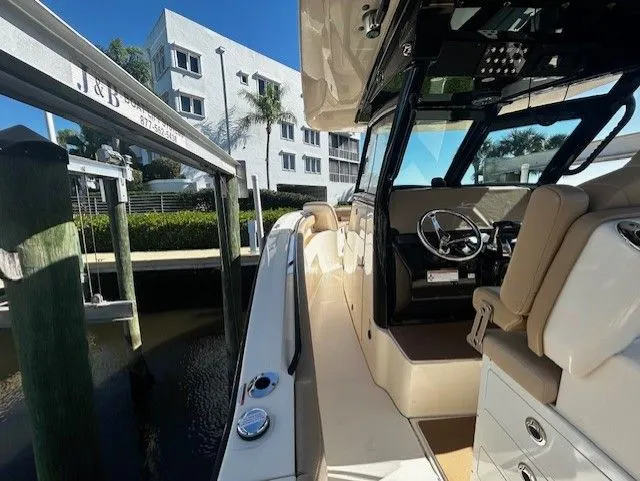 Slide: The Image of Scout 305 LXF 2022 boat docked with modern interior. - 29
