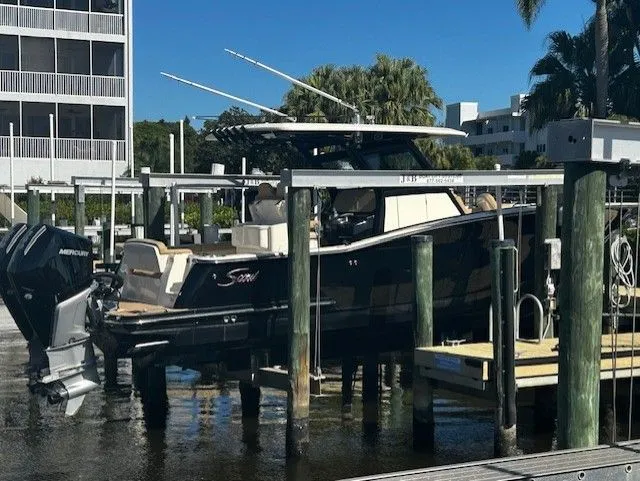 Slide: The Image of Scout 305 LXF 2022 boat docked at marina. - 3