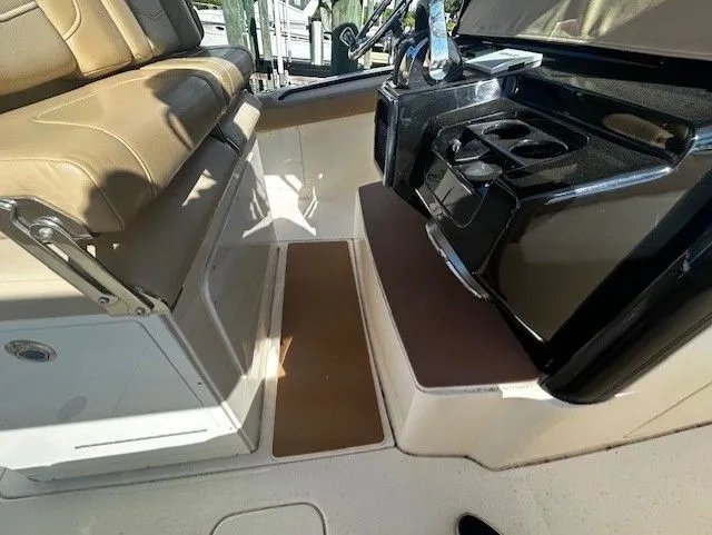 Slide: The Image of Interior of a 2022 Scout 305 LXF boat with seat and helm console. - 32