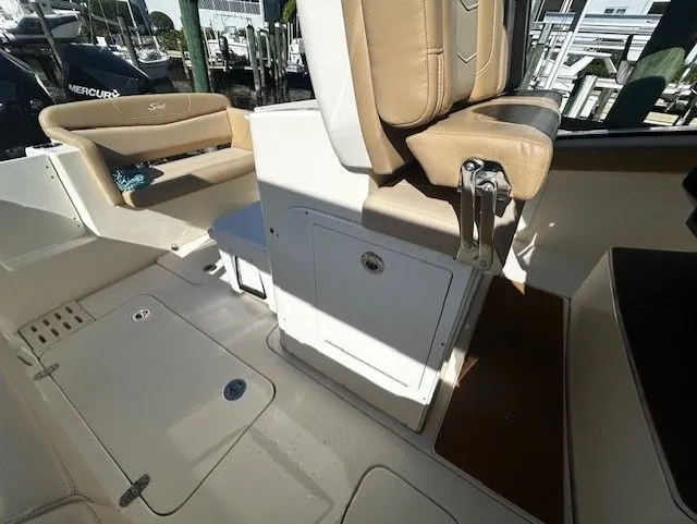 Slide: The Image of Interior of a 2022 Scout 305 LXF boat with beige seating. - 33