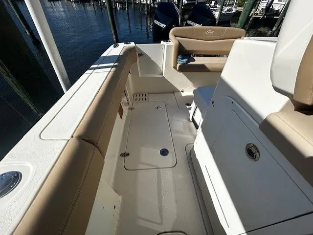 Slide: The Image of Interior of a 2022 Scout 305 LXF boat with beige seating. - 34