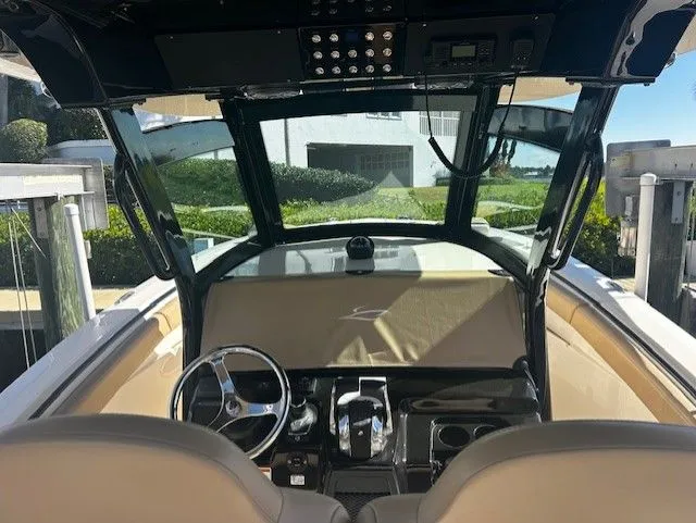 Slide: The Image of 2022 Scout 305 LXF boat cockpit with steering wheel and controls. - 39