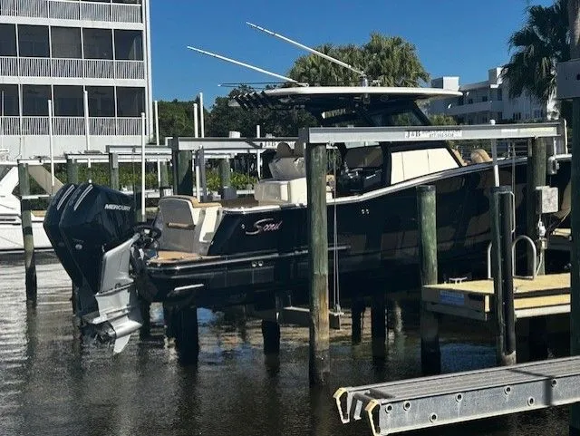 Slide: The Image of 2022 Scout 305 LXF boat docked at marina. - 5