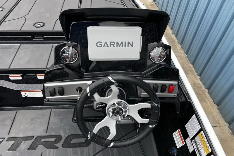 Slide: The Image of 2026 Nitro Z19 XL Pro boat dashboard with Garmin display and steering wheel. - 18