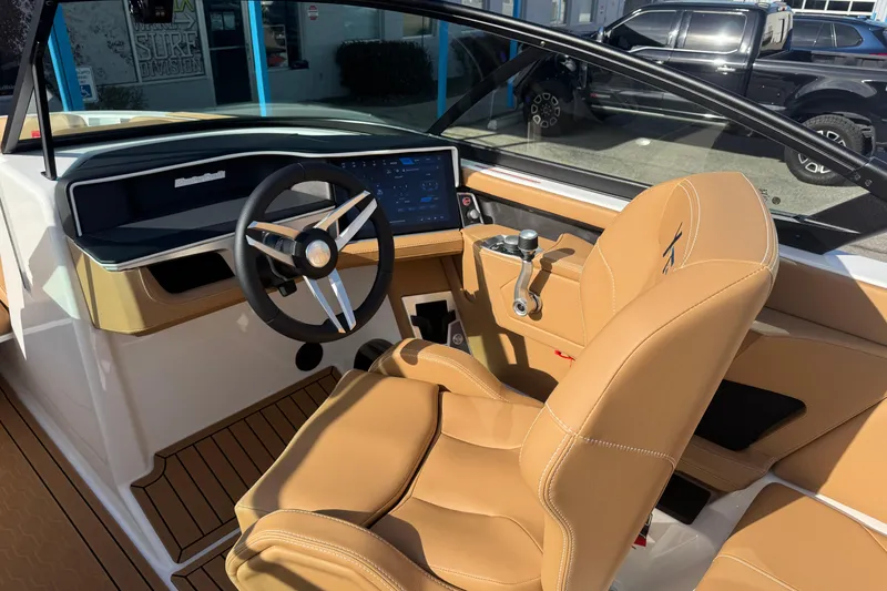 Slide: The Image of 2026 MasterCraft XT24 boat interior with tan leather seats and modern dashboard. - 11
