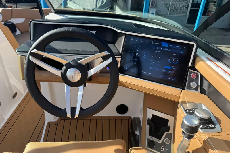 Slide: The Image of 2026 MasterCraft XT24 boat dashboard with modern steering wheel and touchscreen controls. - 12