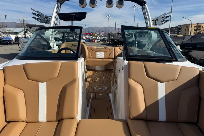 Slide: The Image of 2026 MasterCraft XT24 boat interior with tan seating and modern design features. - 14
