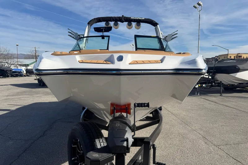 Slide: The Image of 2026 MasterCraft XT24 boat on trailer, front view, in outdoor setting. - 4