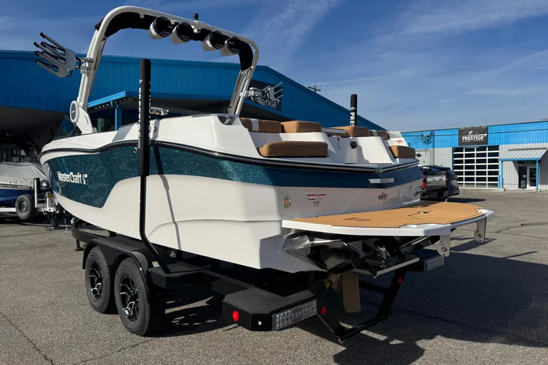 Slide: The Image of 2026 MasterCraft XT24 boat on trailer at dealership, showcasing sleek design and features. - 6