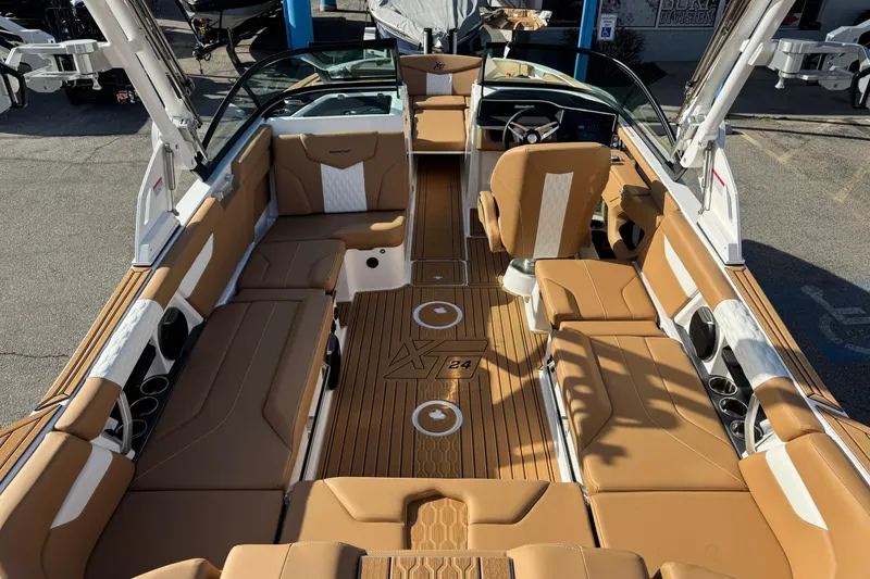 Slide: The Image of 2026 MasterCraft XT24 boat interior with tan seating and modern design. - 9