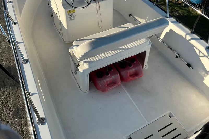 Slide: The Image of 2015 Boston Whaler 170 Montauk interior with seating and fuel containers. - 10