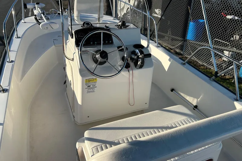 Slide: The Image of 2015 Boston Whaler 170 Montauk boat interior with steering console and seating. - 11