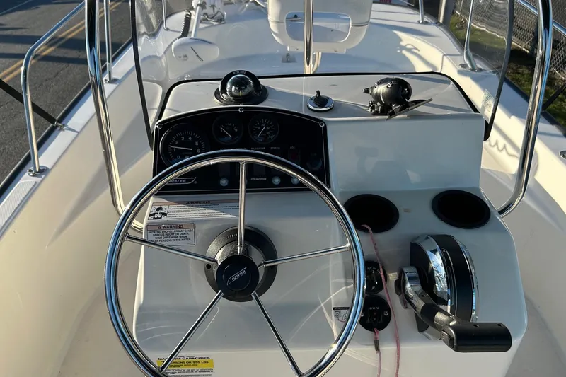 Slide: The Image of 2015 Boston Whaler 170 Montauk boat console with steering wheel and controls. - 12