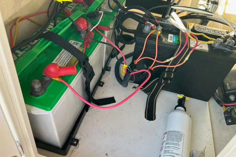 Slide: The Image of Battery compartment of a 2015 Boston Whaler 170 Montauk with wiring and fire extinguisher. - 13