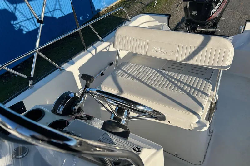 Slide: The Image of 2015 Boston Whaler 170 Montauk boat interior with steering wheel and seating. - 15
