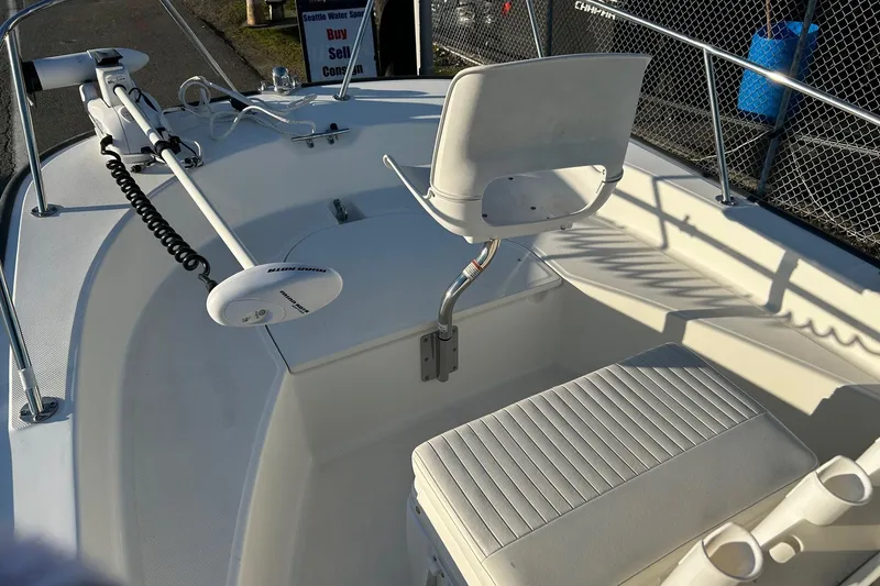 Slide: The Image of 2015 Boston Whaler 170 Montauk boat interior with seating and trolling motor. - 16