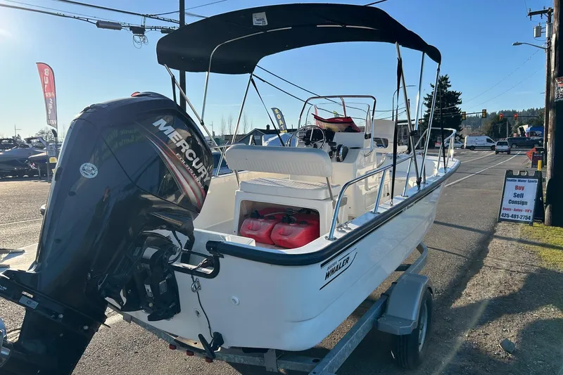 Slide: The Image of 2015 Boston Whaler 170 Montauk boat with Mercury engine on trailer, outdoor display. - 5