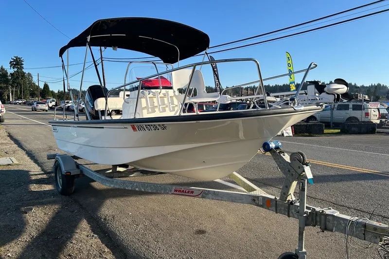 Slide: The Image of 2015 Boston Whaler 170 Montauk boat on trailer, parked outdoors. - 7