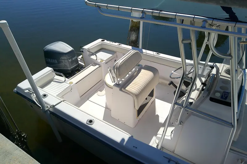 Slide: The Image of 1999 Grady-White Escape 209 boat with Yamaha V200 engine, docked on calm water. - 10