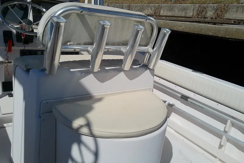 Slide: The Image of 1999 Grady-White Escape 209 boat interior with rod holders and cushioned seating. - 16