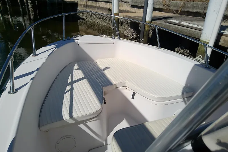 Slide: The Image of 1999 Grady-White Escape 209 boat interior with white cushioned seating. - 19